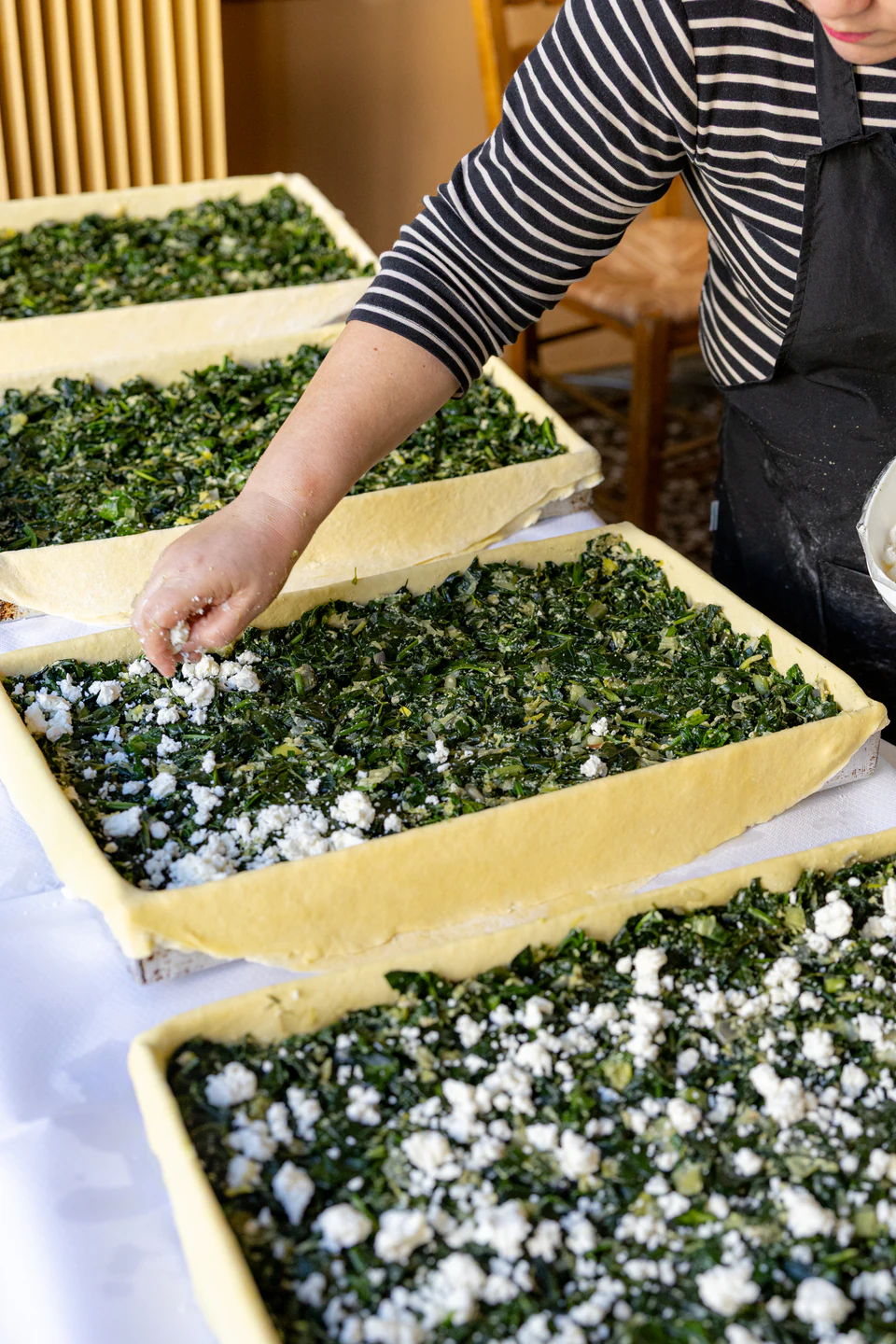 Preparing handmade pies with greens and cheese