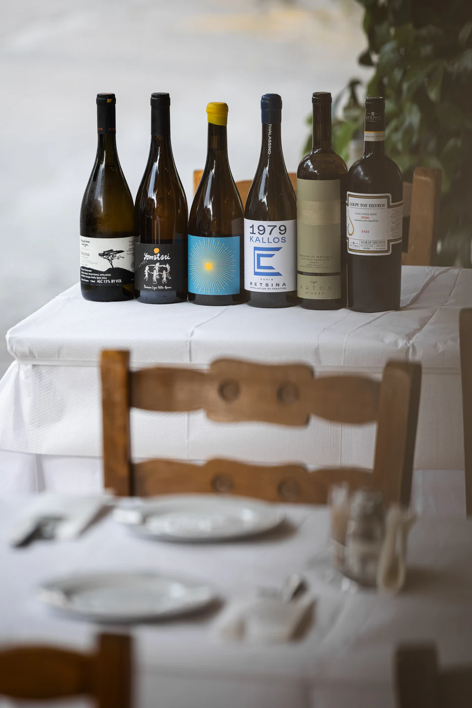 Selected Greek wines beside a dining table